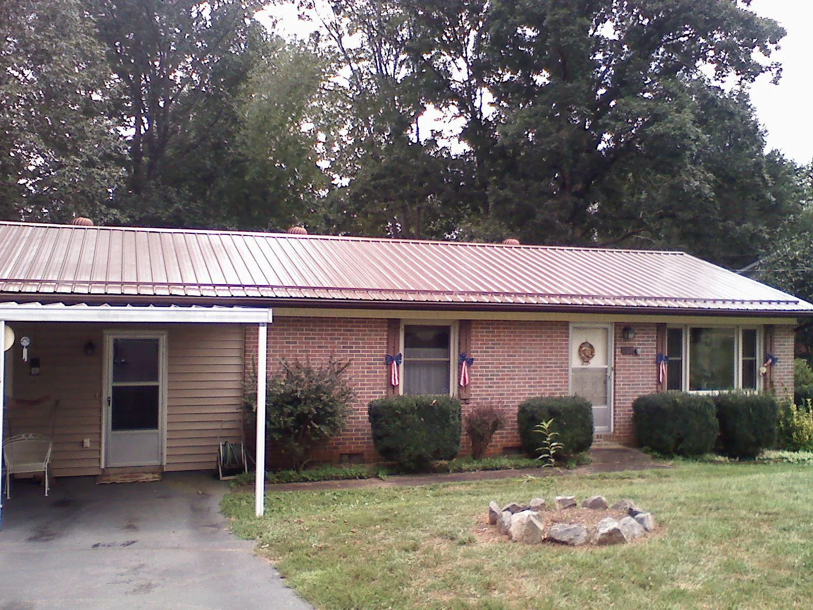 Bronze metal roof and carport on a brick ranch home — Roof Repair work by our crew in Verbank